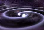 Une image de synthèse extraite de la représentation d'une collision de deux naines blanches. Les ondes gravitationnelles font osciller le tissu de l'espace-temps comme des vagues sur l'eau, juste avant la collision des deux astres compacts. En emportant de l'énergie, ces ondes font décroître la taille de l'orbite d'un système binaire constitué d'astres compacts jusqu'à ce qu'une collision se produise. © GSFC/D. Berry