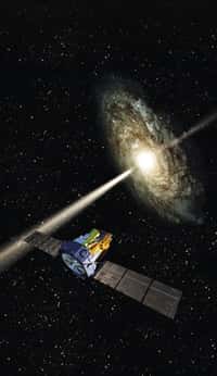Une vue d'artiste du satellite Integral observant un noyau actif de galaxie et ses jets de matière. Crédit : Esa
