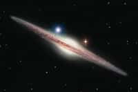 Représentation artistique de la source X, nommée HLX-1 (point lumineux bleu en haut à gauche du bulbe galactique). Elle est située dans la périphérie de la galaxie spirale ESO 243-49. HLX-1 est le candidat le plus solide détecté à ce jour, appartenant à la classe si longtemps recherchée des trous noirs de masse intermédiaire. © Insu/Heidi Sagerud