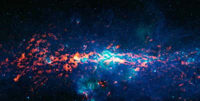 Image composite en couleur du centre galactique et du Sagittaire B2 (Sgr B2). C'est l'un des plus grands nuages de gaz moléculaire de la Voie lactée. Cette région dense se trouve à proximité du centre galactique et est riche en de nombreuses molécules interstellaires différentes. Sgr B2 est la région orange-rouge vif au milieu à gauche de l'image, qui est centrée sur le centre galactique. © ESO/Apex et MSX/Ipac/Nasa