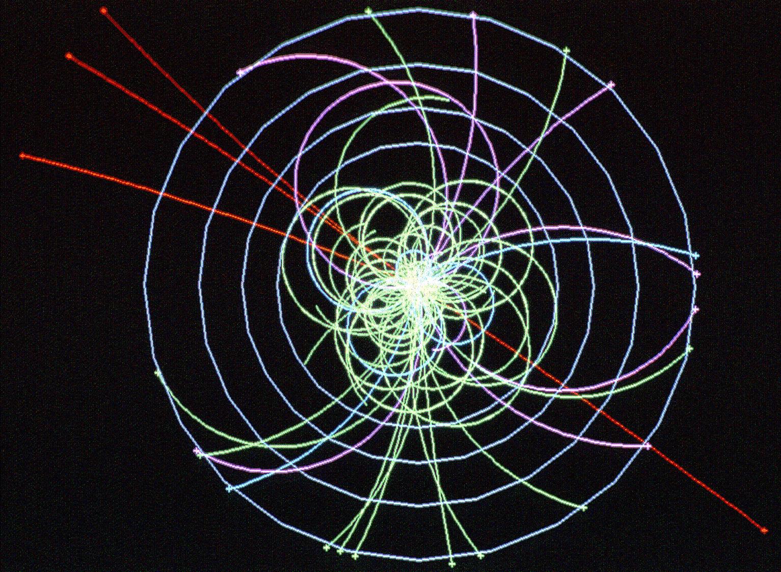 Une simulation de la découverte du Boson de Higgs dans le détecteur d'Atlas. La particule se signale par la production simultanée de 4 muons, lourds cousins de l'électron, dont les trajectoires sont en rouge. Crédit : Cern