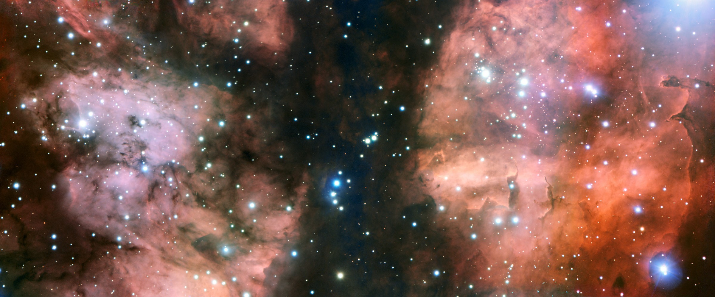 Le très grand télescope de l'ESO, le VLT, a pris l'image la plus détaillée d'une partie spectaculaire de la nurserie stellaire appelée NGC 6357. L'image montre de nombreuses jeunes étoiles chaudes, des nuages de gaz lumineux et des formations de poussière bizarres sculptées par le rayonnement ultraviolet et les vents stellaires. © ESO