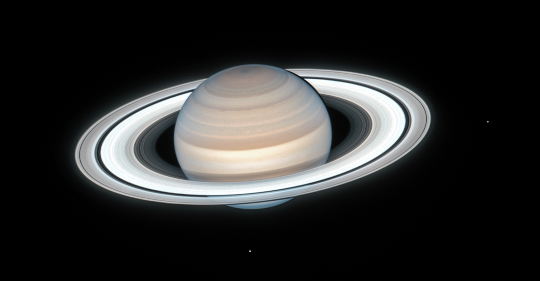 L’atmosphère de Saturne est principalement composée d’hydrogène et d’hélium. On y trouve des traces d’ammoniac, de méthane, de vapeur d’eau et d’hydrocarbures qui lui donnent une couleur brun jaunâtre. Cette dernière image prise par le télescope spatial Hubble montre aussi deux des satellites de la planète aux anneaux : Mimas à droite et Encelade en bas. © Nasa, ESA, A. Simon (Goddard Space Flight Center), M.H. Wong (University of California, Berkeley), and the OPAL Team