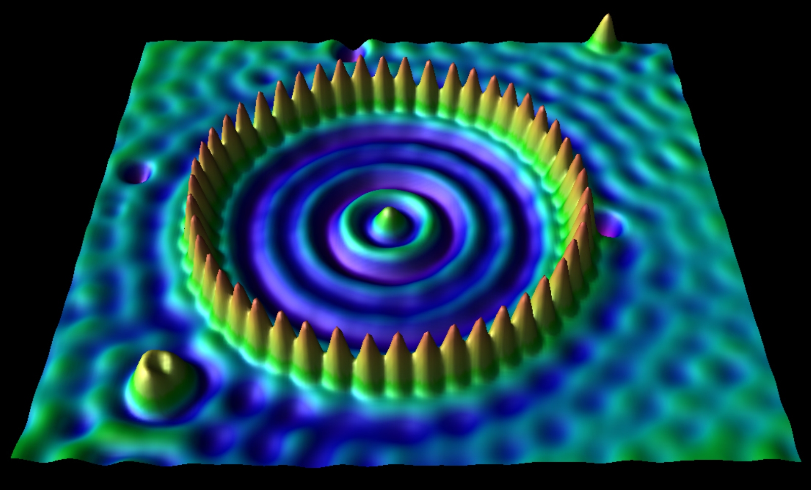 Cette image montre à l'aide d'un microscope à effet tunnel une surface de cuivre d'environ 5 nanomètres où les atomes de cuivre ont été confinés à l'intérieur d'un enclos de 48 atomes de fer. © IBM Almaden Visualization Lab