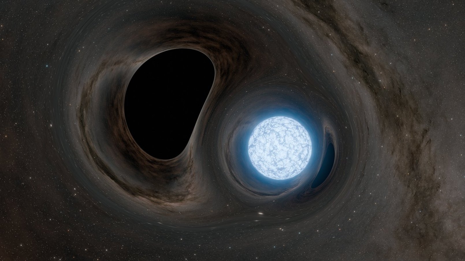 Vue d'artiste d'un trou noir en orbite autour d'une étoile à neutrons fissurée. Avant qu'un trou noir ne consume une étoile à neutrons, les forces de marée de son immense gravité cisaillent la surface de l'étoile, provoquant des séismes et l'ouverture de failles. Dans cette œuvre, la gravité du trou noir et de l'étoile à neutrons déforme notre vision de l'arrière-plan. L'étoile à neutrons, bien que moins massive que le trou noir, possède une gravité suffisamment forte pour déformer également la vision du trou noir. © Caltech/R. Hurt (IPAC)