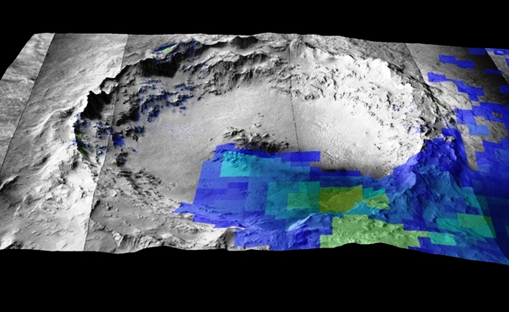 Le cratère Mojave a été formé il y a quelques millions d'années. Il est aujourd'hui identifié comme étant la source du plus grand groupe de météorites martiennes (les shergottites). Les pixels colorés montrent la présence de minéraux mafiques (pyroxène et olivine) identifiés par les instruments Omega et Crism (respectivement à bord des sondes Mars Express et MRO), et qu'on trouve également dans les météorites martiennes à partir d'analyses en laboratoire. © Esa, Stephanie C. Werner, Anouck Ody, François Poulet